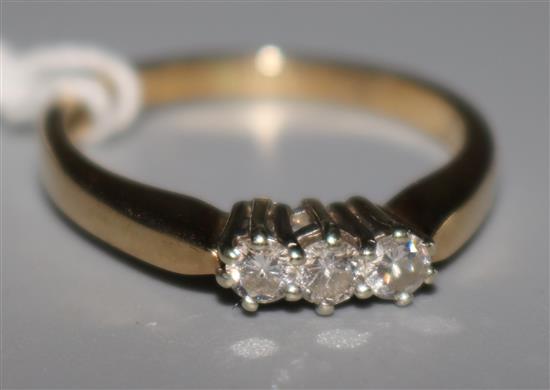 A 9ct gold and three stone diamond ring, size N.
